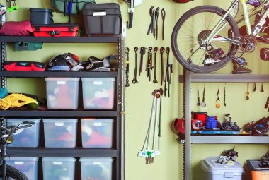 An image depicting a well-organized garage showcasing various types of outdoor gear stored neatly. This could include bicycles hanging from ceiling hooks, shelving units filled with camping equipment, and bins labeled with seasonal gear.